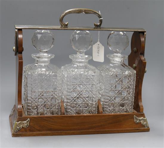 A Betjemanns walnut three decanter tantalus, lacking keys